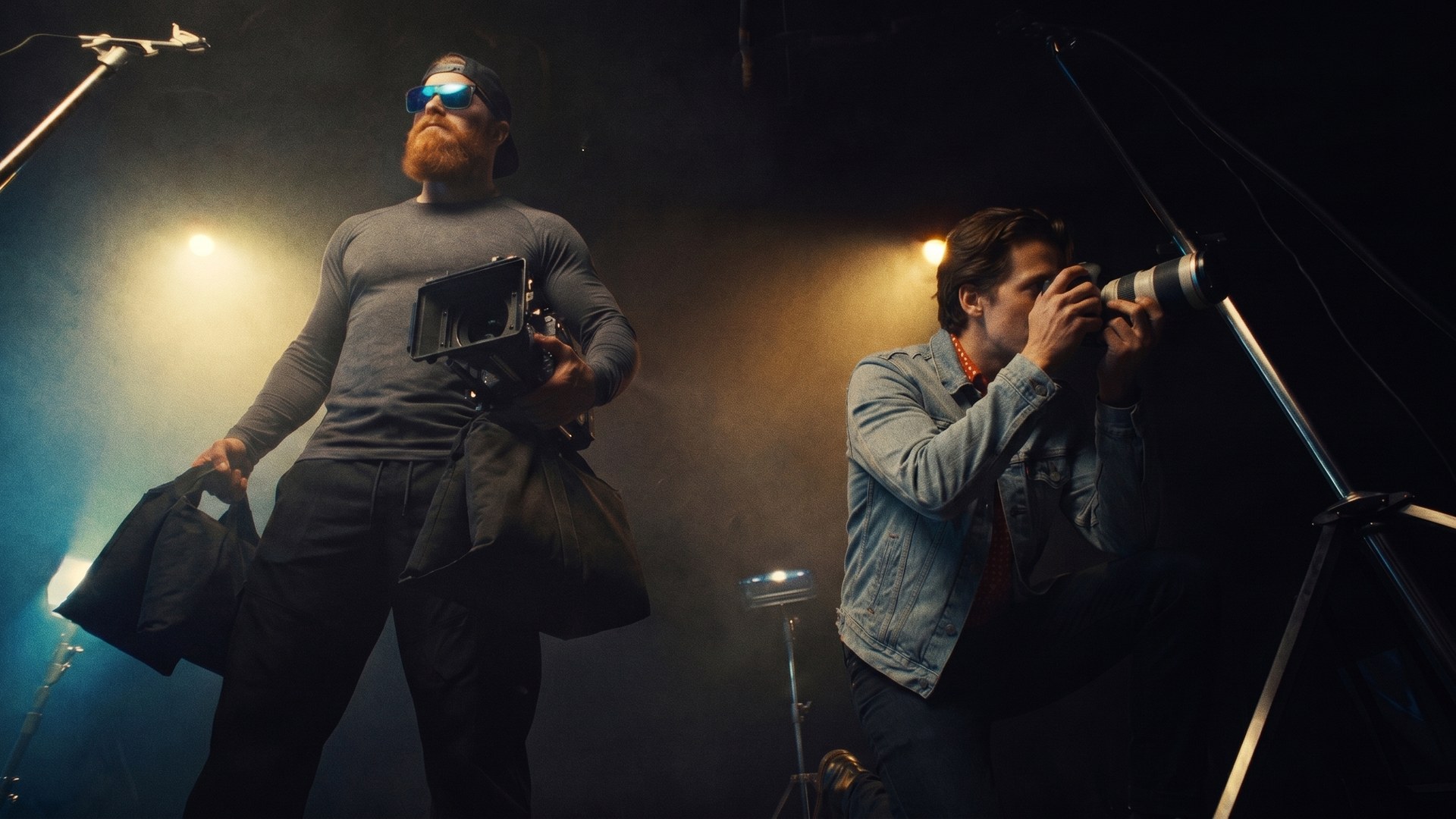 Alan Larsen on a soundstage — camera in one hand, sandbag in the other